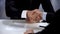 Businessmen shaking partners hand, signed contract, cooperation close-up