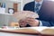 Businessmen sit counting money in baht in the office, preparing to distribute salaries and bonuses or contributions to employees