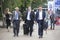 Businessmen with suitcases are walking along South bank