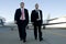 Businessmen walking away from corporate jet