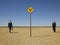 Businessmen Walking Towards Road Sign In Desert