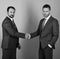 Businessmen wear smart suits and ties. Men with beard and serious faces make deal or agreement. CEOs shake hands on blue