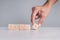 Businessmen wear a white shirt at their desks in the office. Use your hand to pick up a wooden cube inscribed with the word bonus