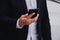 Businessmen wearing a black suit are holding mobile phones