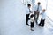 Businessmen and woman standing together by railing and conversing