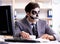 Businessmsn with scary face mask working in office