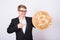 Businessnan holding big golden bitcoin on pink background. Crypto currency, virtual money, internet and economics