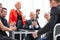 Businesspeople applauding in conference room during meeting