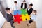 Businesspeople assembling jigsaw puzzle