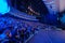 Businesspeople attending global seminar in illuminated blue auditorium