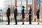 Businesspeople With Boxes Standing In A Line