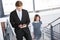 Businesspeople climbing staircase in office