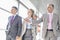 Businesspeople communicating while walking on train platform