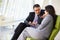 Businesspeople With Digital Tablet Sitting In Modern Office