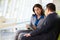 Businesspeople With Digital Tablet Sitting In Modern Office