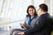 Businesspeople With Digital Tablet Sitting In Modern Office