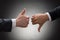 Businesspeople hands showing thumb up and thumb down
