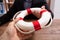 Businesspeople Holding A Lifebuoy In Hands