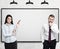 Businesspeople near a blank whiteboard