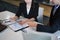 Businesspeople reviewing financial documents together in office.