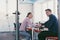 businesspeople, rivalry and people concept - businesswoman and businessman arm wrestling during corporate meeting in