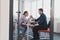 Businesspeople, rivalry and people concept - businesswoman and businessman arm wrestling during corporate meeting in