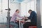 Businesspeople, rivalry and people concept - businesswoman and businessman arm wrestling during corporate meeting in