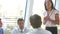 Businesspeople Seated Around Table Having Meeting