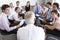 Businesspeople Seated In Circle At Company Seminar