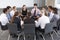 Businesspeople Seated In Circle At Company Seminar