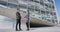 Businesspeople shaking hands - Professionals Greeting Outside Office Building