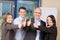 Businesspeople Showing Thumbs Up Sign In Office