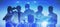 Businesspeople silhouettes standing on abstract blue city background. Network and communication concept.
