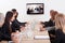 Businesspeople Sitting At Conference Table