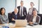 Businesspeople smiling in conference room