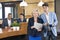 Businesspeople Standing At Reception Counter