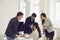 Businesspeople team in a meeting discussing a startup project at a table in an office with windows.