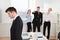 Businesspeople Teasing Businessman In Office