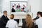 Businesspeople Videoconferencing At Workplace