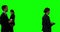 Businesspeople walking against green screen