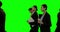 Businesspeople walking against green screen