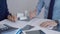 Businesspeople working at a grey glass table. Two accountants or auditors are using a calculator for counting taxes or