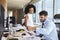 Businesspeople Working At Office Desk On Computer Together