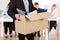 Businessperson Carrying Cardboard Box