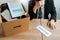 Businessperson carrying packing personal company on brown cardboard Box and resignation letters for quit or change of job leaving