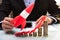 Businessperson Flying Rocket Over Stacked Coins And Arrow