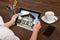 Businessperson Looking At House Photo On Digital Tablet