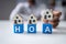 Businessperson Placing House Model Over Hoa Blocks