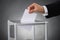 Businessperson Putting Ballot In Box