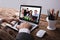 Businessperson Video Conferencing With Colleague On Laptop